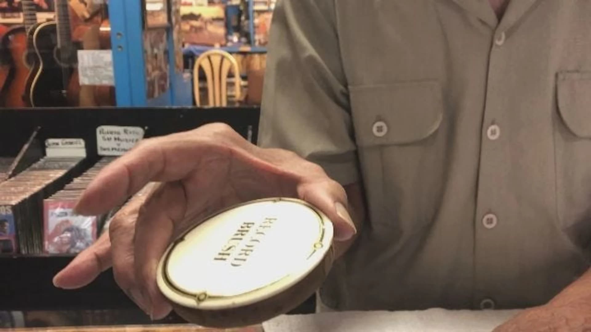 Latin music store owner shows off memorabilia