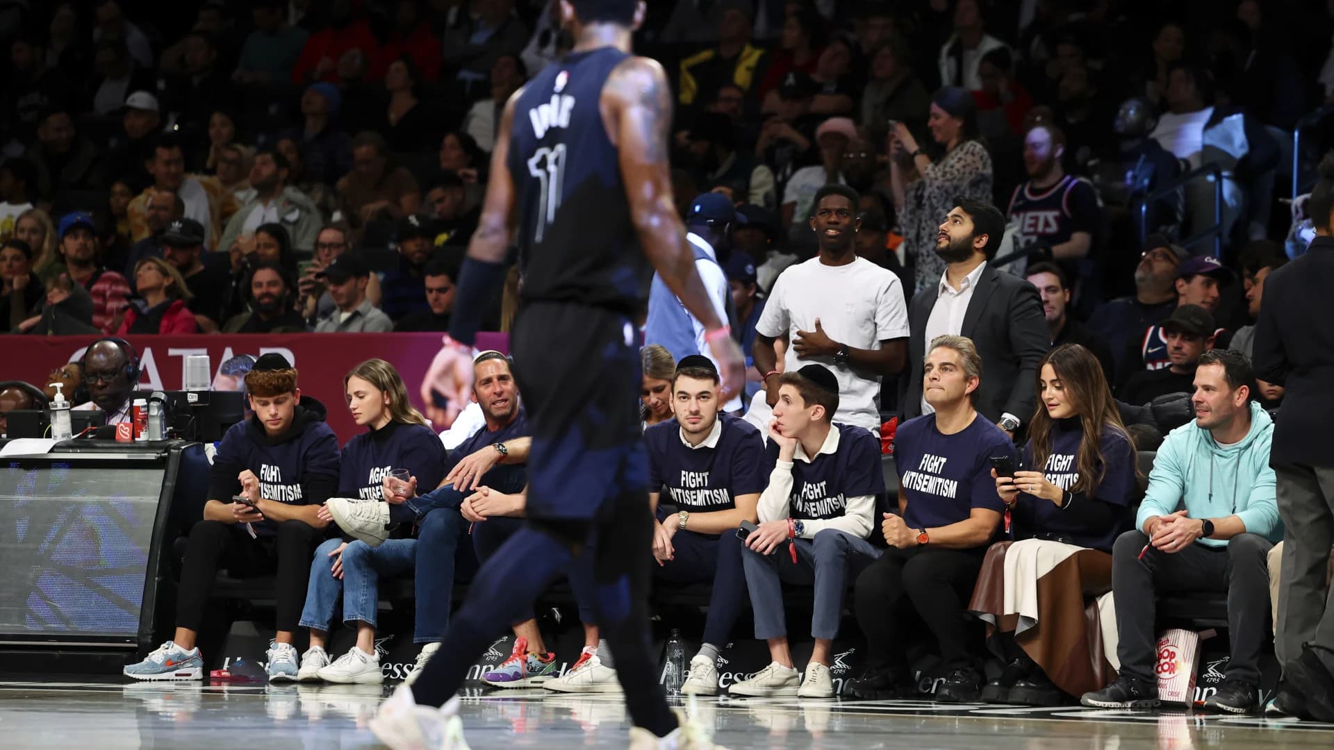 Fans in 'Fight Antisemitism' shirts courtside at Nets game
